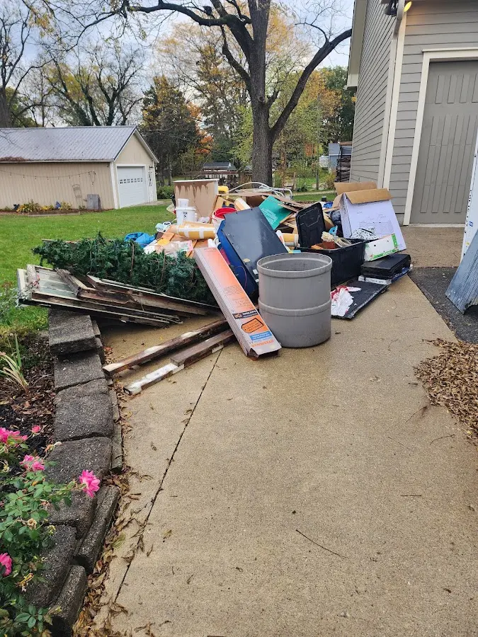 Dumpster being loaded with debris for Commercial Dumpster Rental in Pleasant Hill